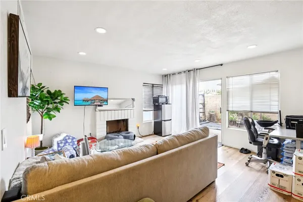 a living room with furniture fireplace and a large window