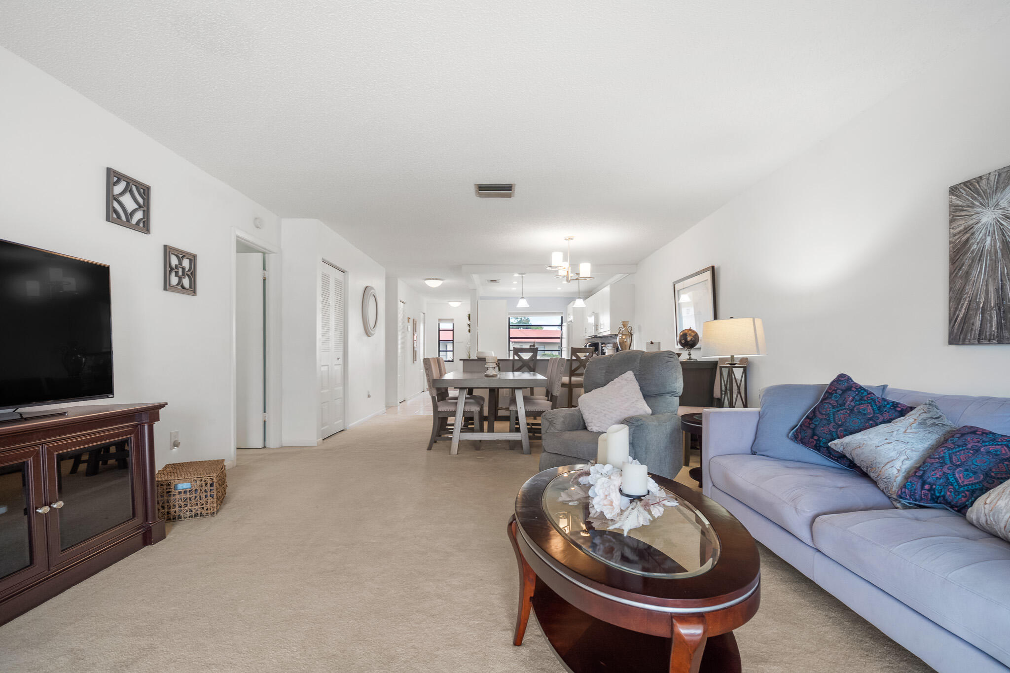 21218 Lago Circle, Unit F Boca Raton, FL 33433 - Photo 19 of 40 a living room with furniture and a flat screen tv