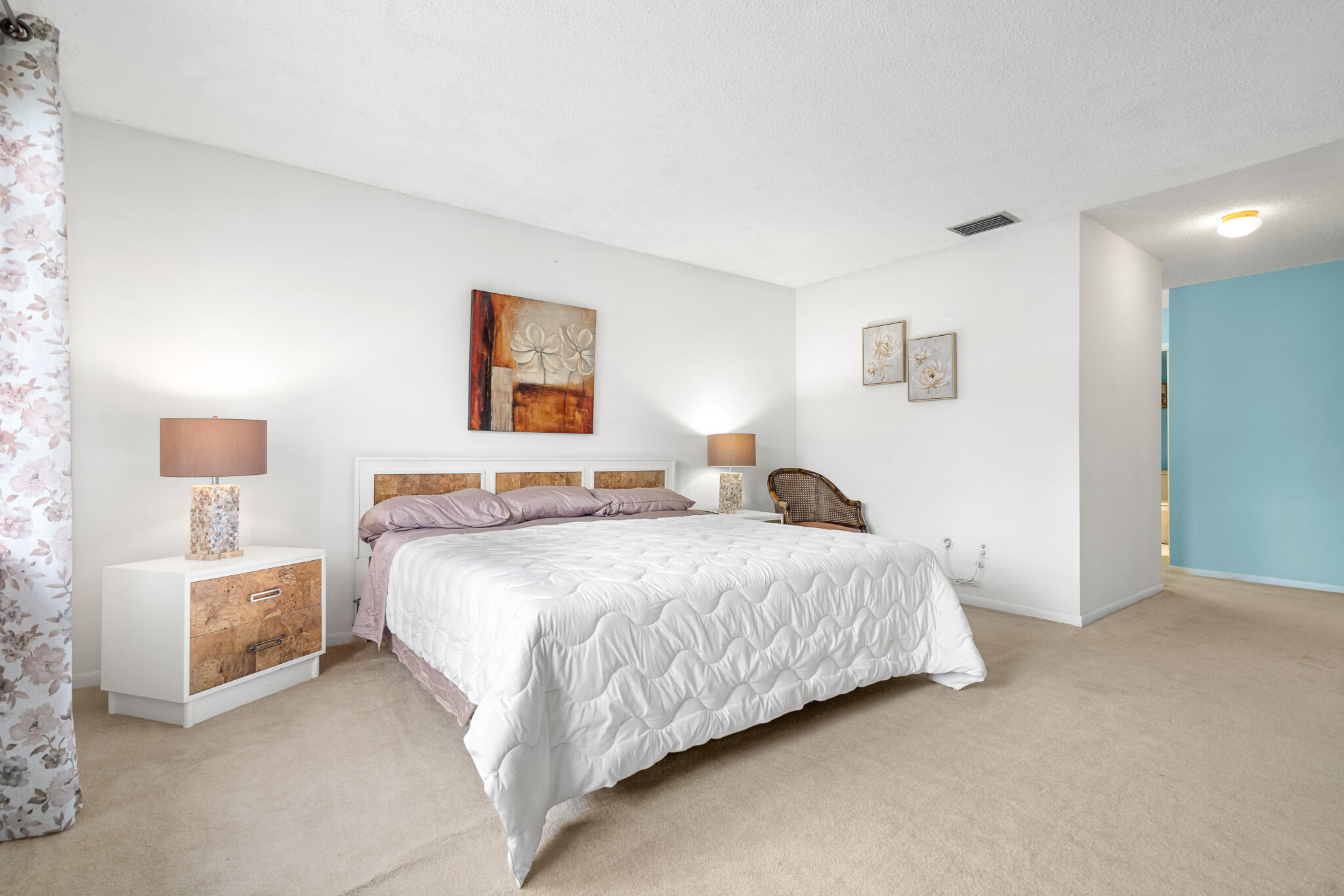 21218 Lago Circle, Unit F Boca Raton, FL 33433 - Photo 20 of 40 a bedroom with a bed and a night stand
