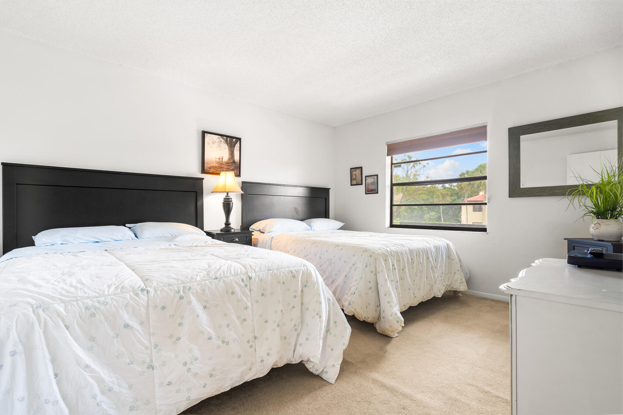 21218 Lago Circle, Unit F Boca Raton, FL 33433 - Photo 28 of 40 a bedroom with two beds and a window