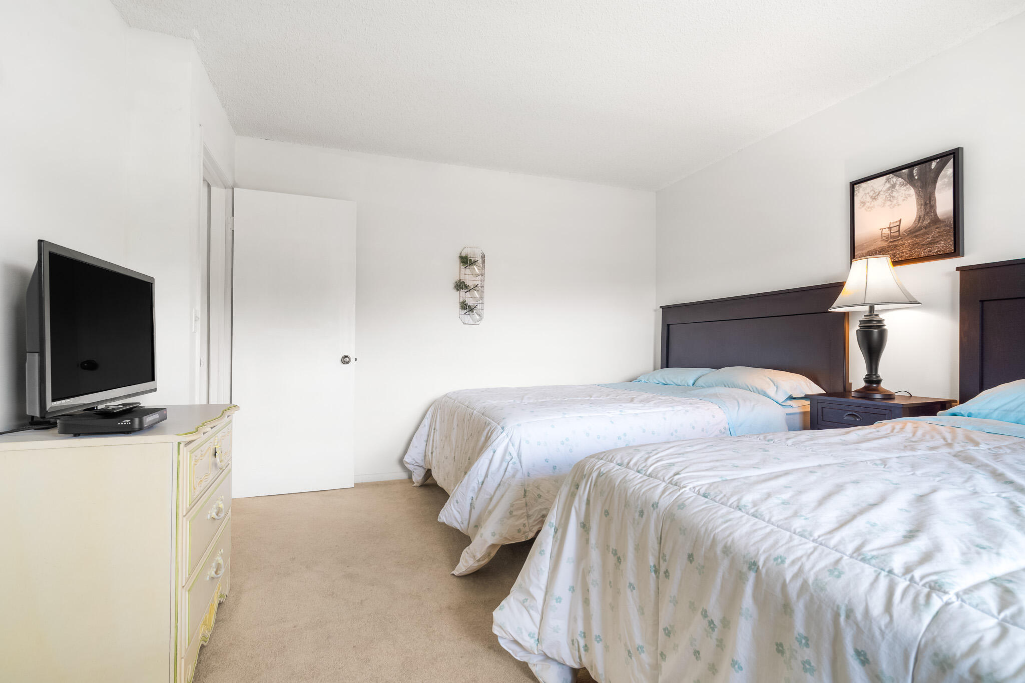 21218 Lago Circle, Unit F Boca Raton, FL 33433 - Photo 29 of 40 a bedroom with a bed and a flat screen tv