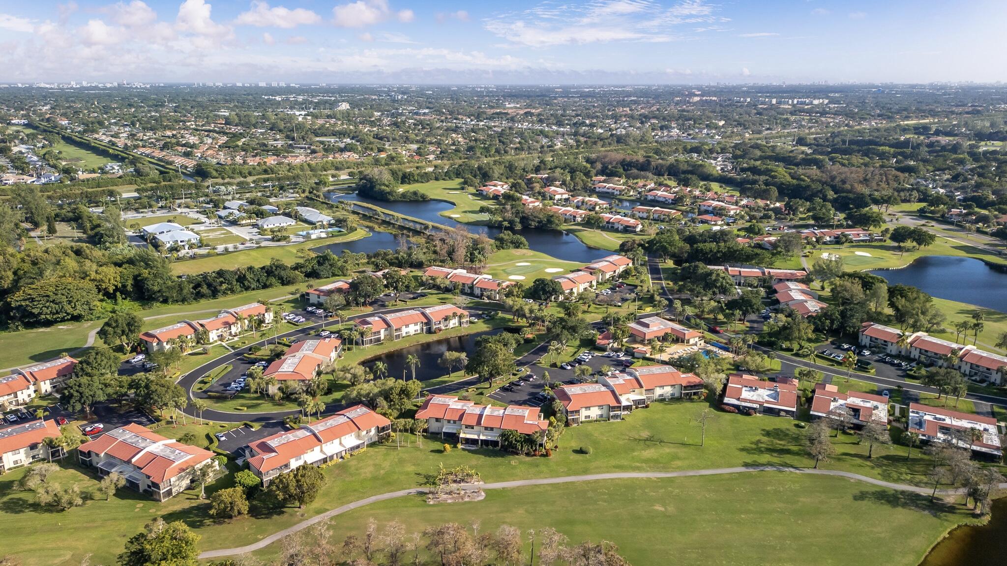 21218 Lago Circle, Unit F Boca Raton, FL 33433 - Photo 3 of 40 an aerial view of residential houses with outdoor space and trees