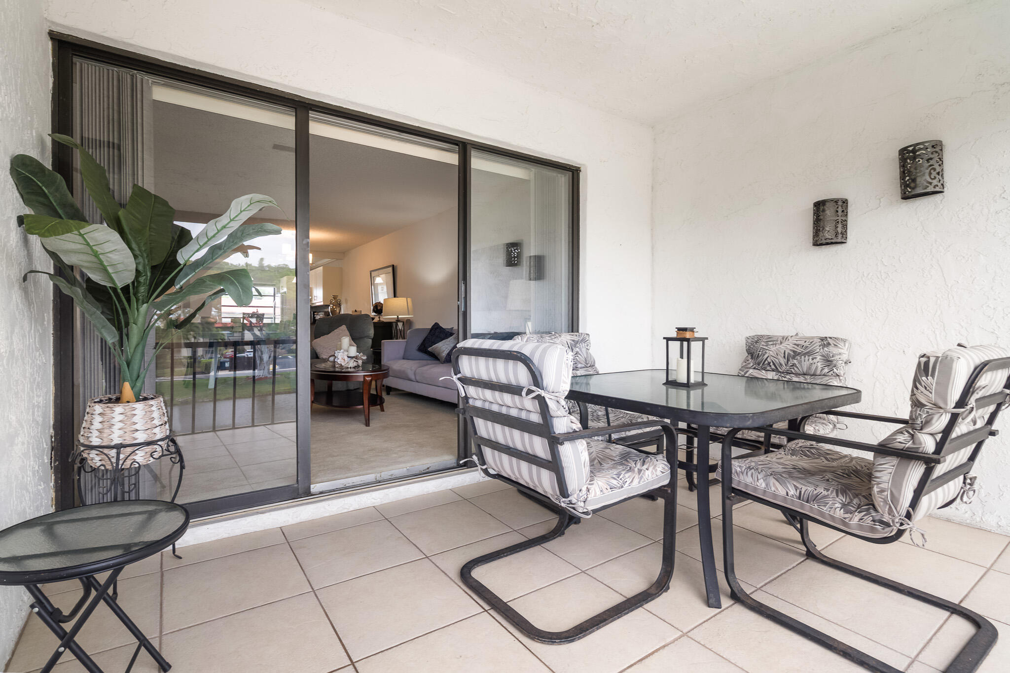 21218 Lago Circle, Unit F Boca Raton, FL 33433 - Photo 31 of 40 a dining room with furniture and a floor to ceiling window
