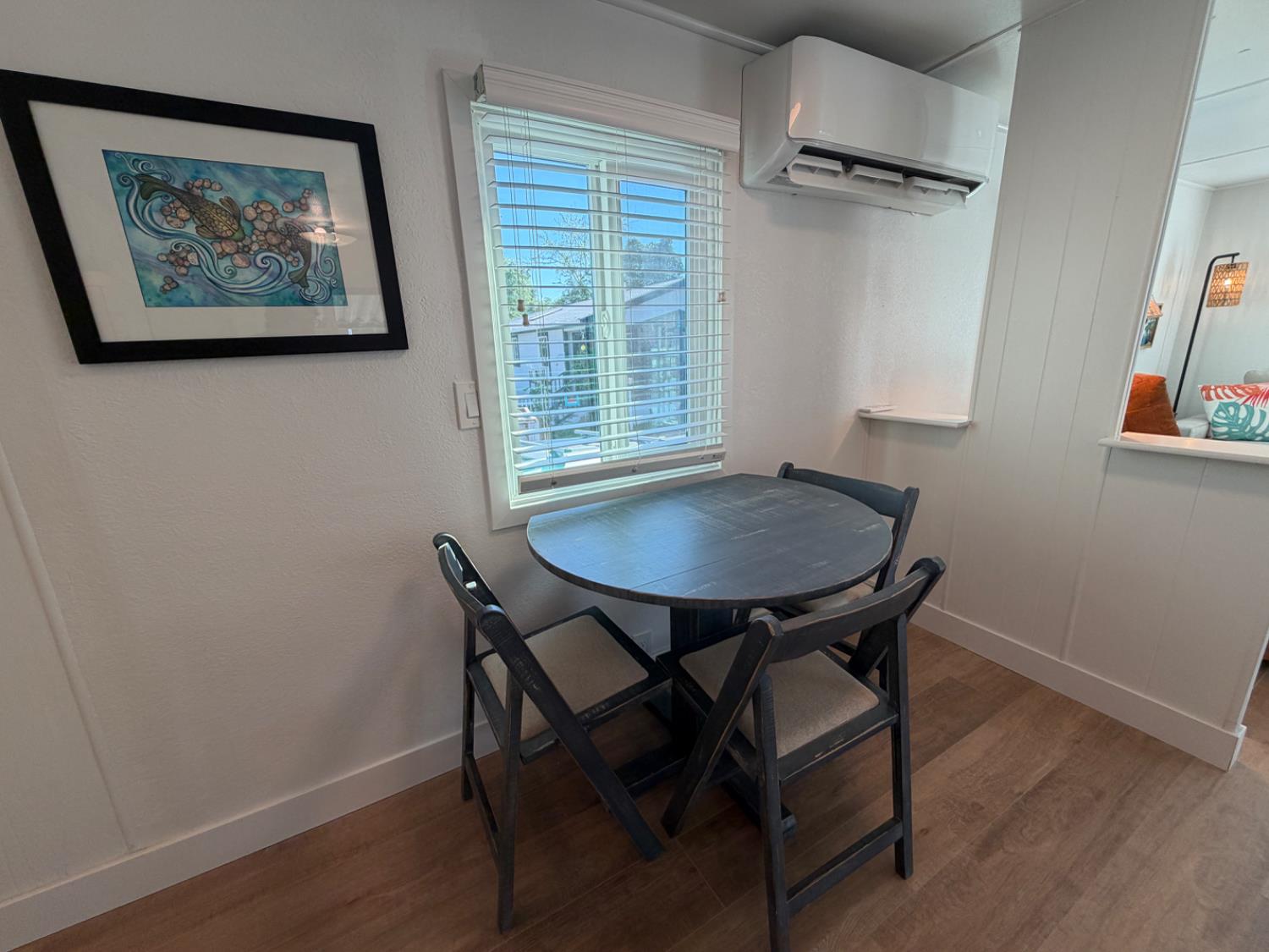 9060 Auburn Folsom Road, Unit 19 Granite Bay, CA 95746 - Photo 10 of 30 a view of a dining room with furniture and wooden floor