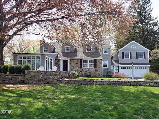 82 Catalpa Road Wilton, CT 06897 - Photo 1 of 1 a front view of a house with a garden and trees
