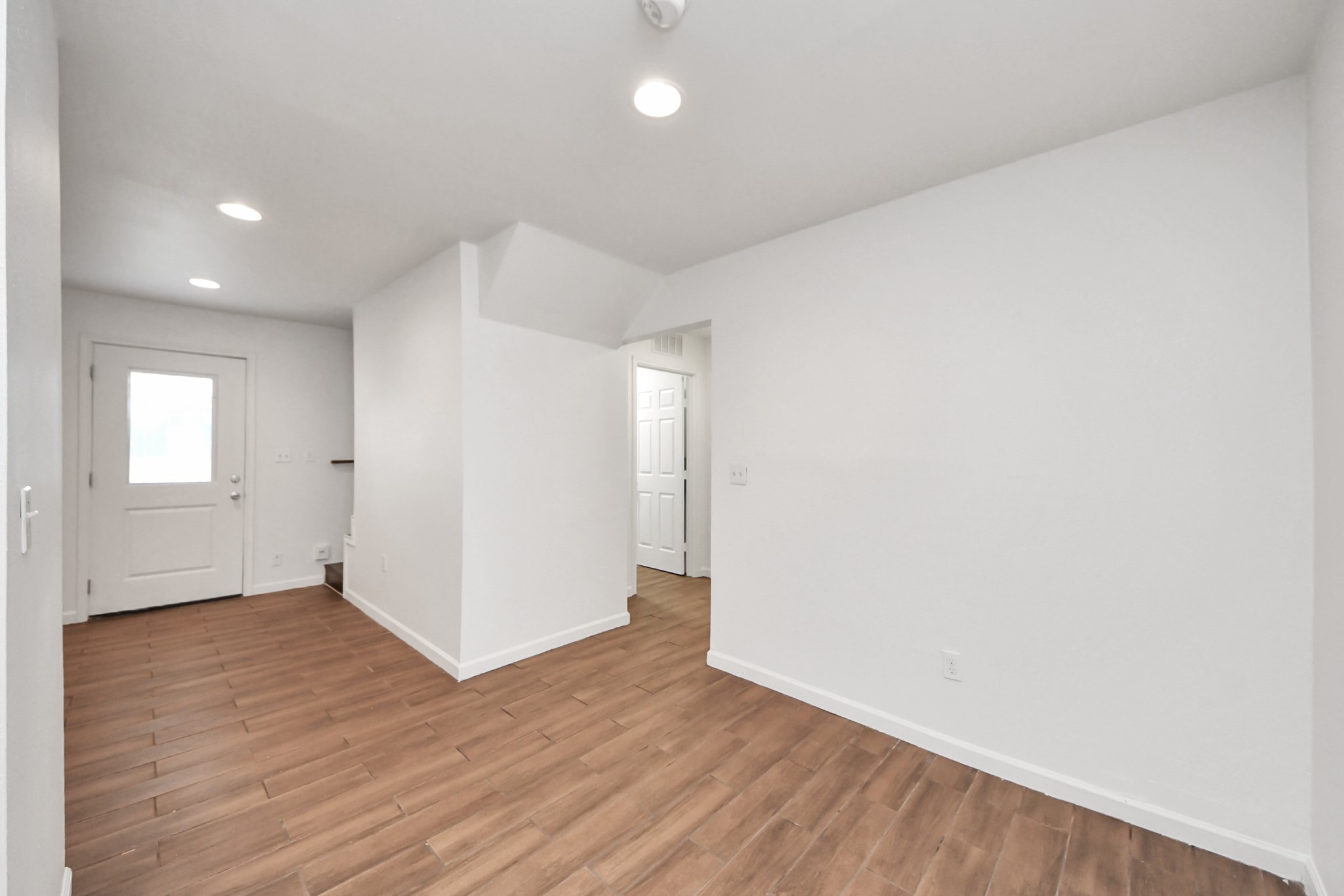 12068 Beechnut Street, Unit C Houston, TX 77072 - Photo 11 of 40 an empty room with wooden floor and windows