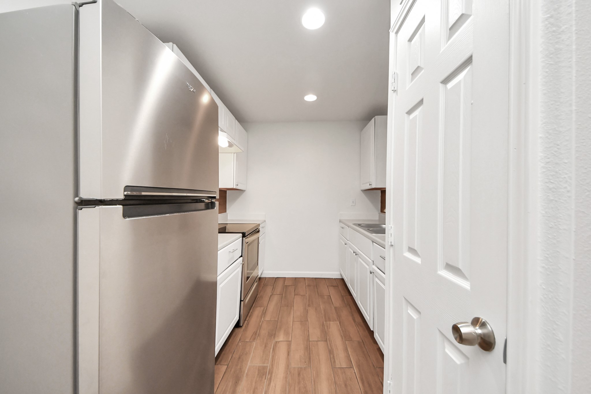 12068 Beechnut Street, Unit C Houston, TX 77072 - Photo 13 of 40 a view of a hallway with wooden floor and staircase