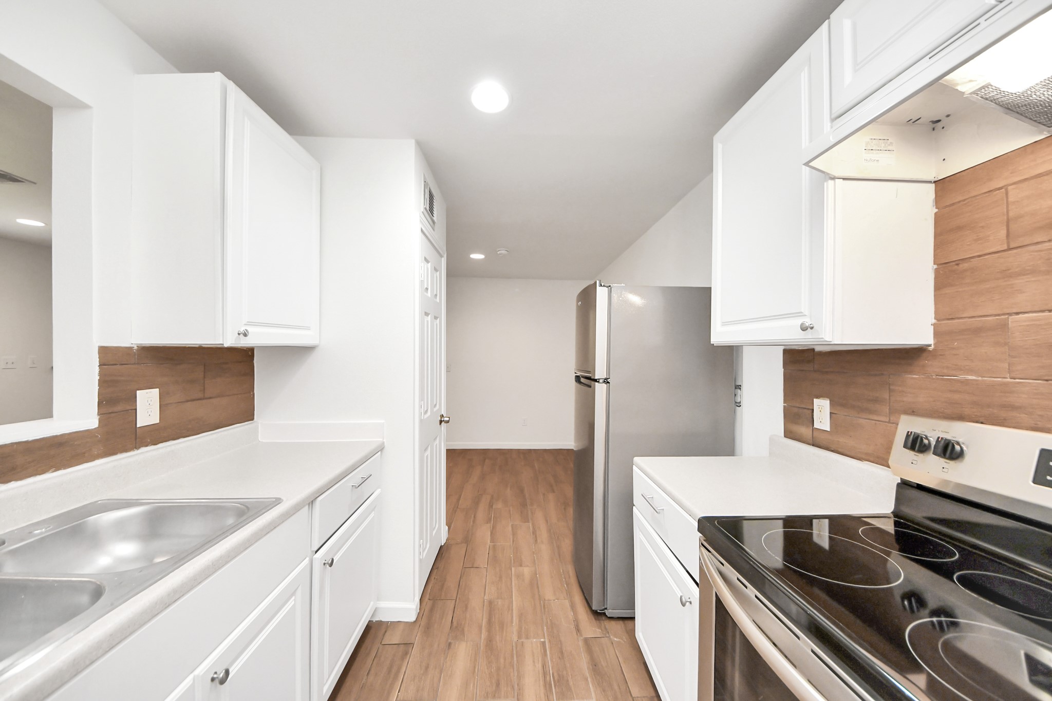 12068 Beechnut Street, Unit C Houston, TX 77072 - Photo 15 of 40 a kitchen with a sink and a stove top oven