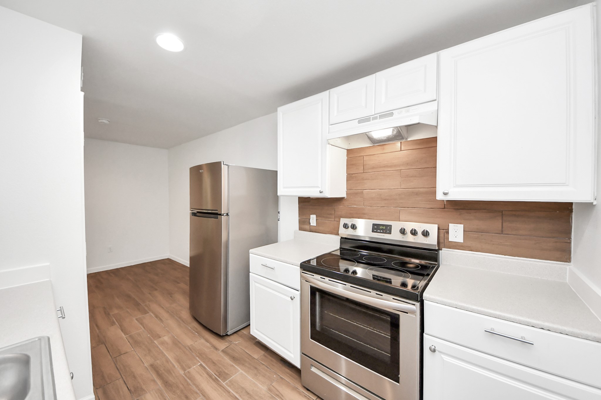 12068 Beechnut Street, Unit C Houston, TX 77072 - Photo 16 of 40 a kitchen with granite countertop a stove and a refrigerator