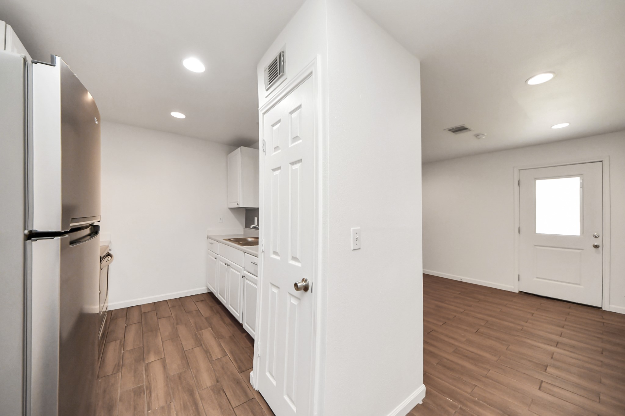 12068 Beechnut Street, Unit C Houston, TX 77072 - Photo 18 of 40 a kitchen with a refrigerator and white cabinets