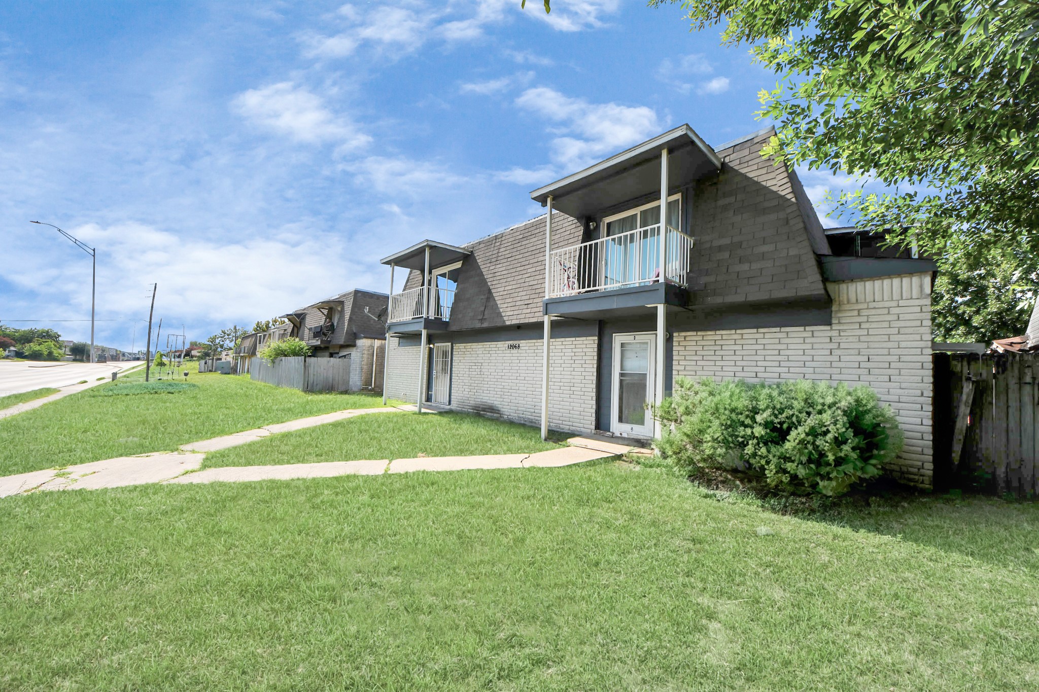 12068 Beechnut Street, Unit C Houston, TX 77072 - Photo 2 of 40 a front view of a house with a yard