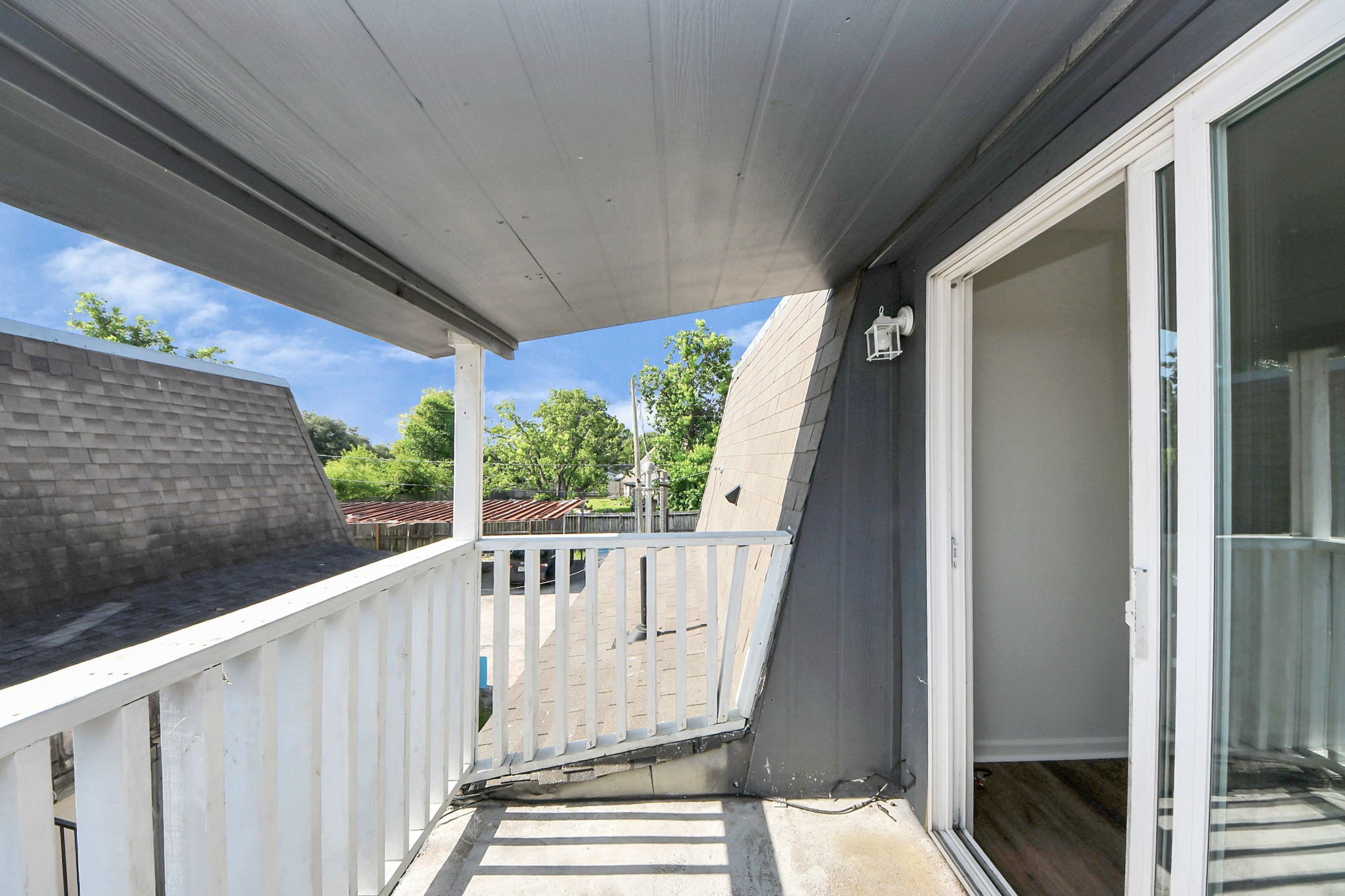 12068 Beechnut Street, Unit C Houston, TX 77072 - Photo 39 of 40 a view of balcony with wooden floor and fence
