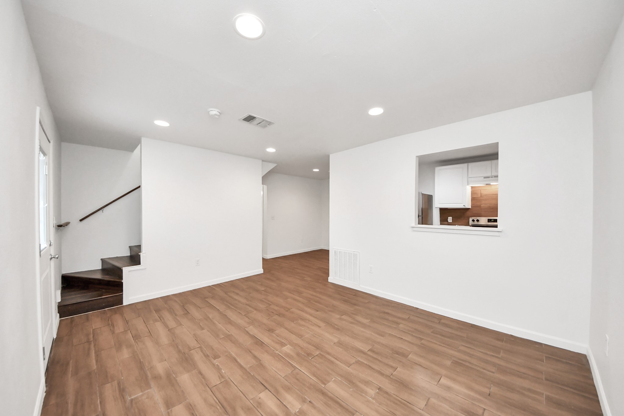 12068 Beechnut Street, Unit C Houston, TX 77072 - Photo 9 of 40 a view of a big room with wooden floor and stairs