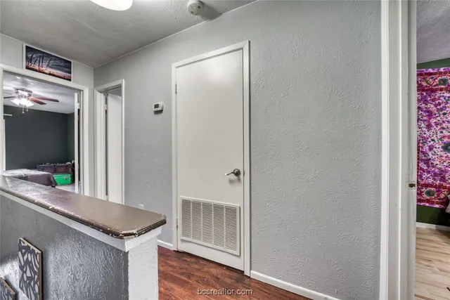 a view of a hallway and an dining rom with furniture