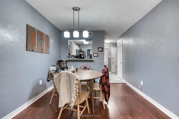 a view of a dining room with furniture wooden floor and chandelier