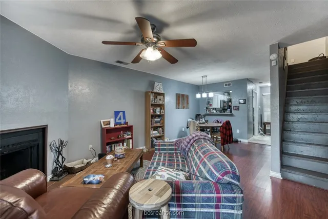 a living room with furniture and a wooden floor