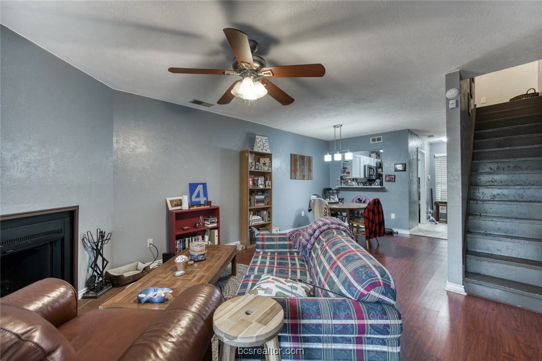 3802 College Main Street, Unit 12 Bryan, TX 77801 - Photo 6 of 11 a living room with furniture and a wooden floor