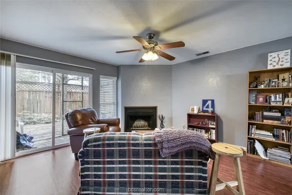 a bedroom with a bed a bookshelf and a chandelier
