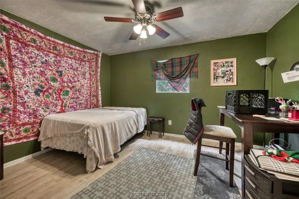 a bedroom with a bed and dresser