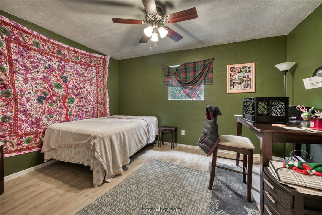 3802 College Main Street, Unit 12 Bryan, TX 77801 - Photo 10 of 11 a bedroom with a bed and dresser