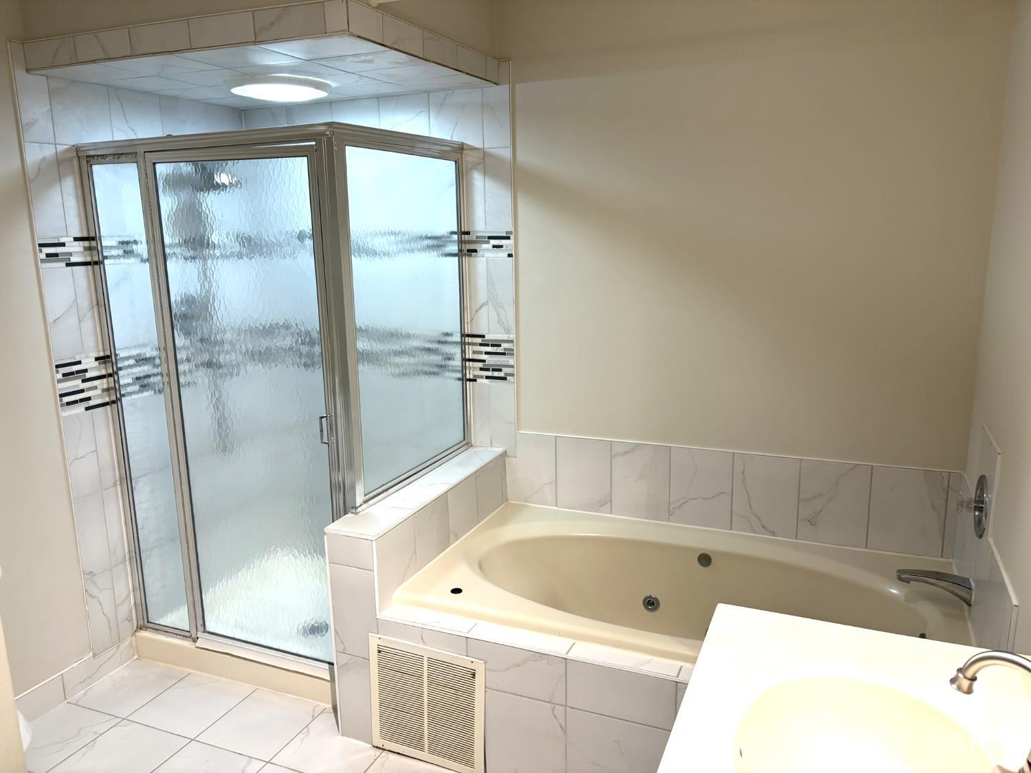 285 Greenfield Road Bridgewater, NJ 08807 - Photo 16 of 26 a bathroom with a tub a sink and a shower