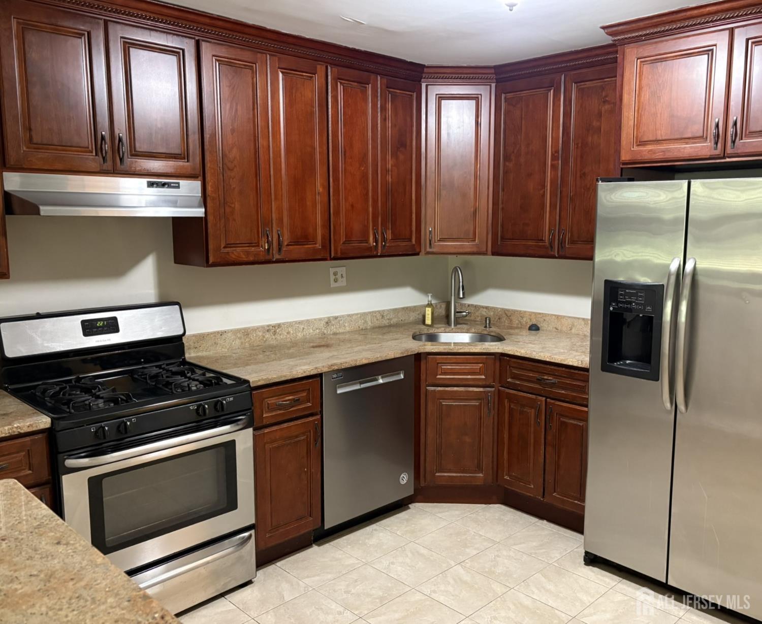 285 Greenfield Road Bridgewater, NJ 08807 - Photo 9 of 26 a kitchen with granite countertop stainless steel appliances and wooden cabinets