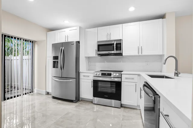 a kitchen with stainless steel appliances a refrigerator stove and microwave