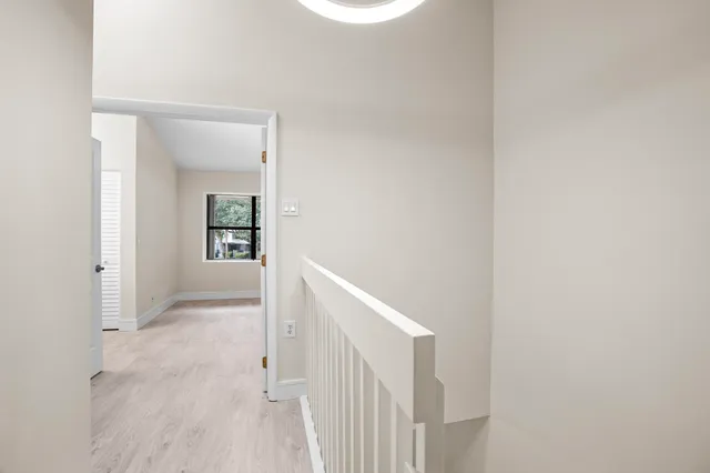 a view of a hallway with wooden floor