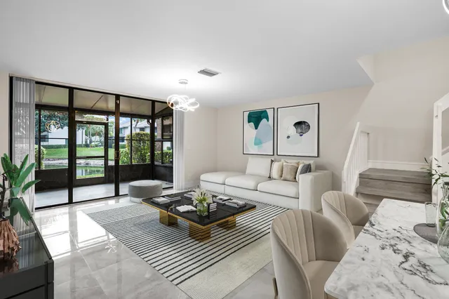 a living room with furniture and a floor to ceiling window