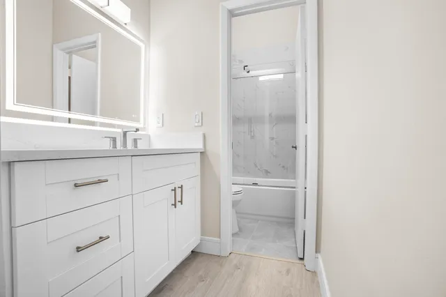 a bathroom with a toilet and a shower