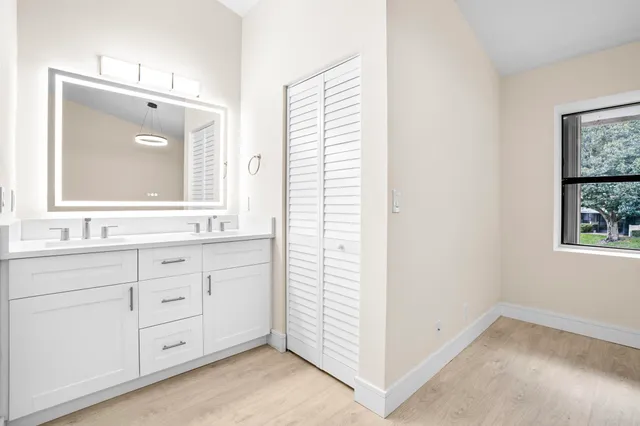 a white toilet next to a bathroom