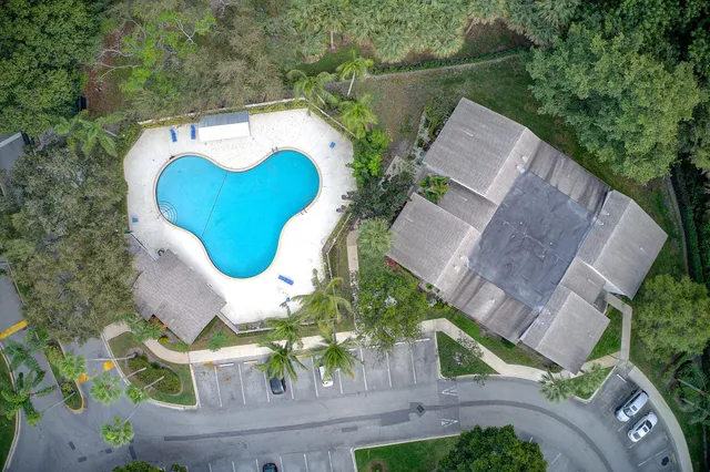 an aerial view of a house with outdoor space and lake view
