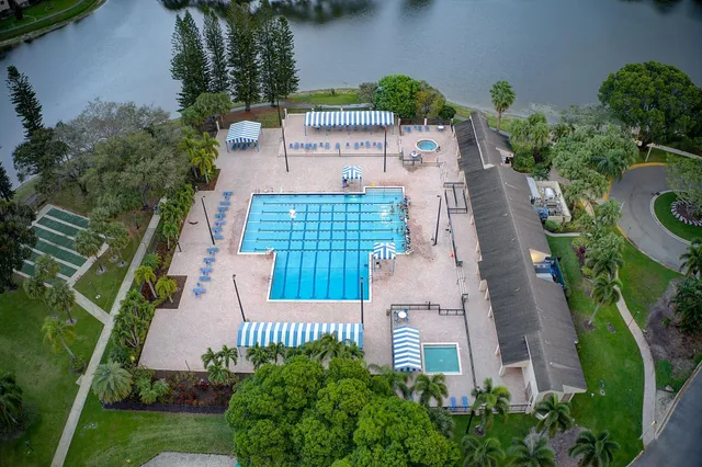 an aerial view of residential houses with outdoor space and trees