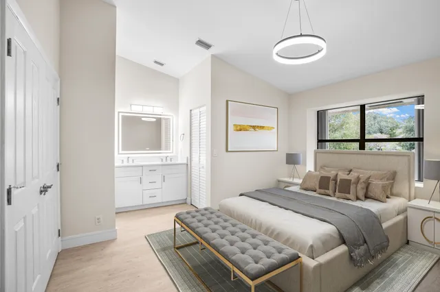 a bedroom with a bed and glass walk in closet