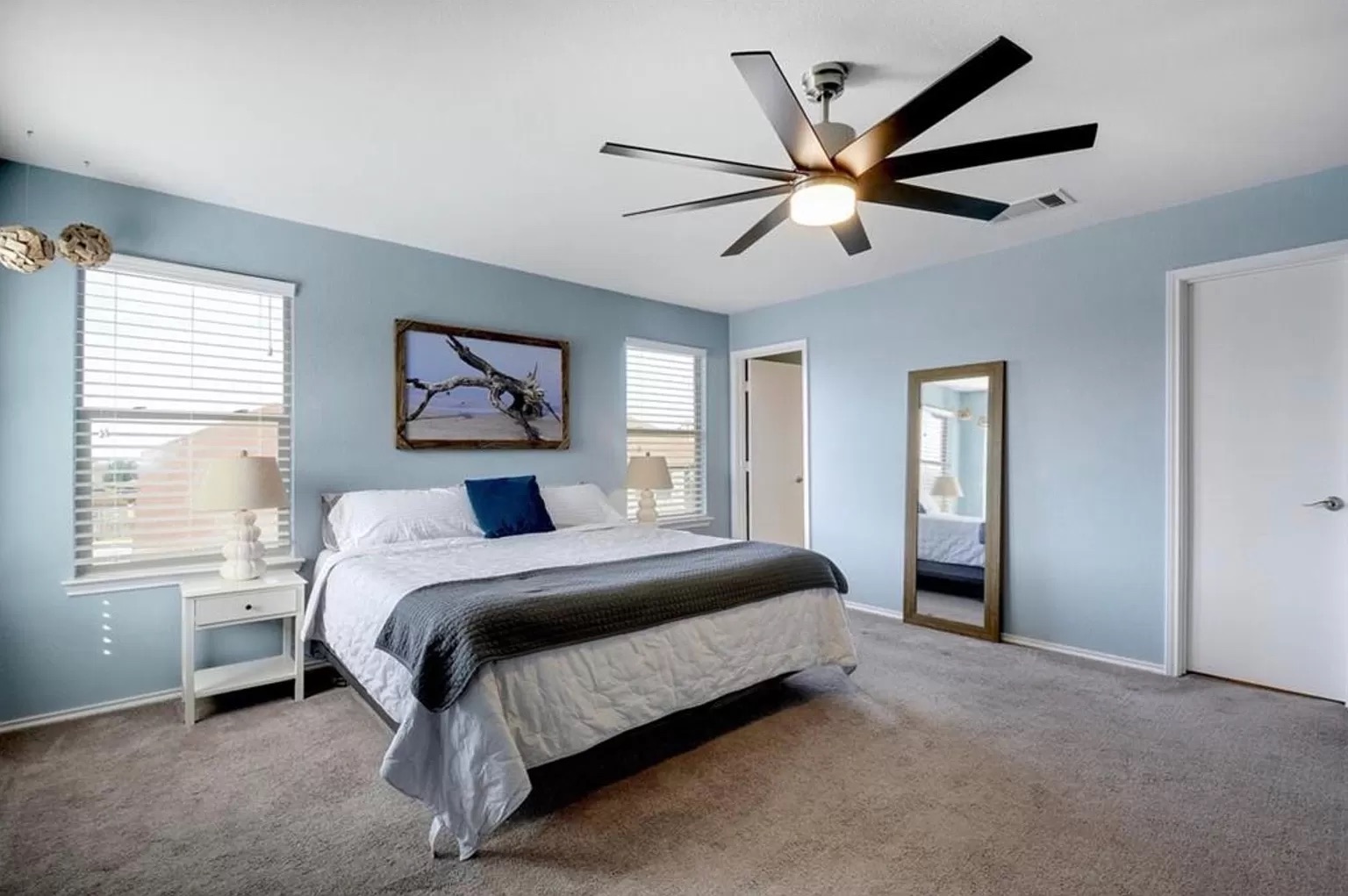 9016 Ridgewell Road Austin, TX 78747 - Photo 11 of 30 A well-lit bedroom features plush carpeting and a modern ceiling fan for ultimate comfort.