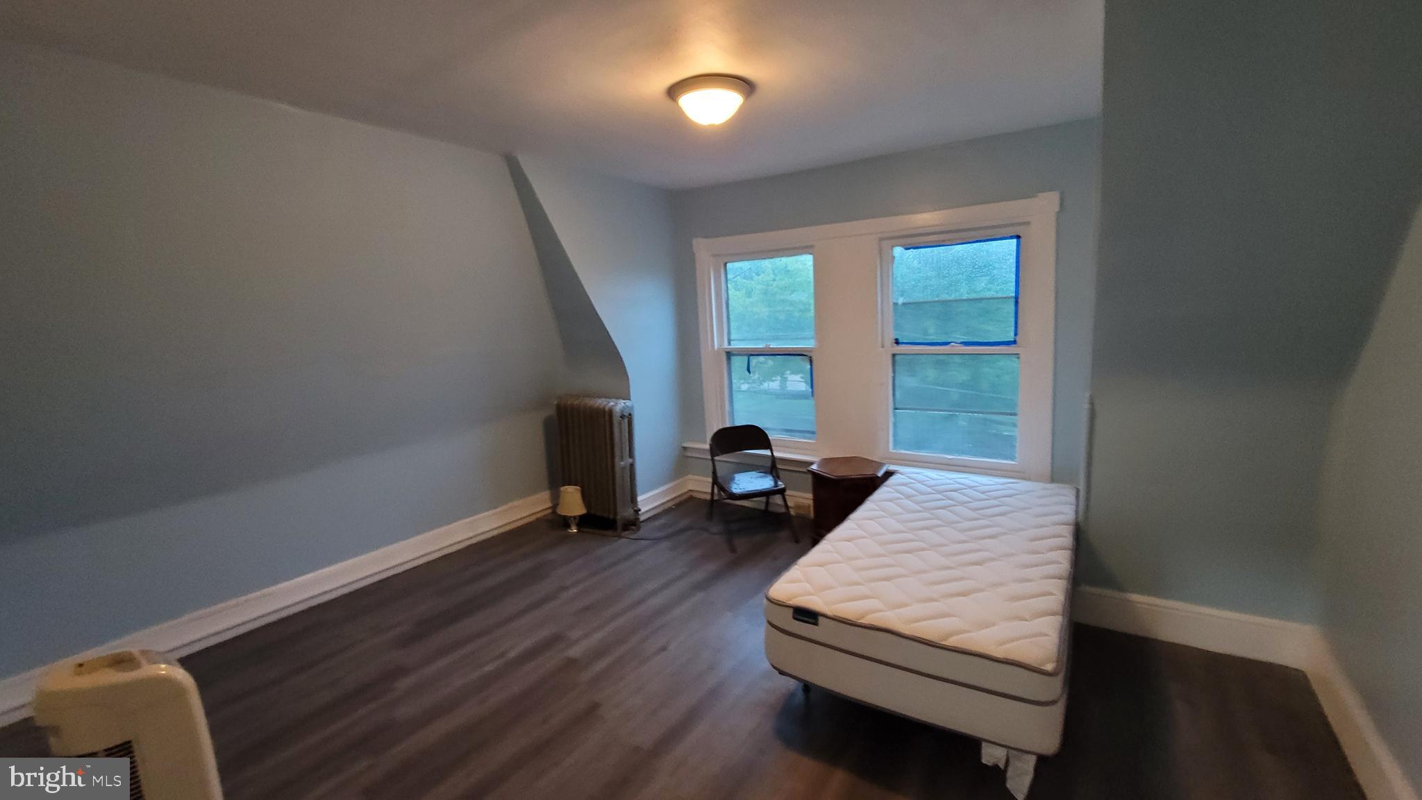 324 Spring Street, Unit 3 Reading, PA 19601 - Photo 16 of 27 a living room with furniture and a wooden floor