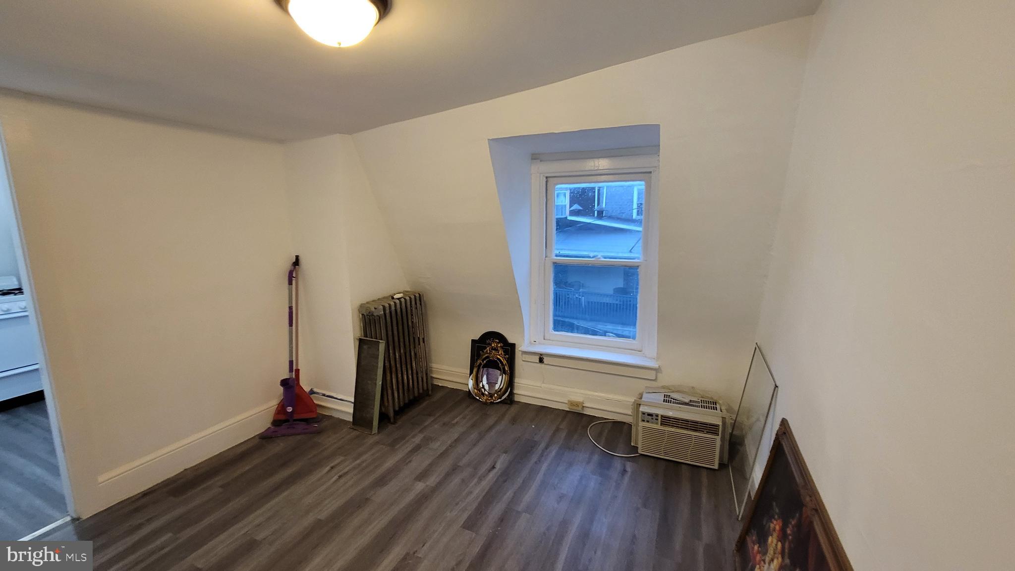 324 Spring Street, Unit 3 Reading, PA 19601 - Photo 20 of 27 a view of a room with wooden floor and a window