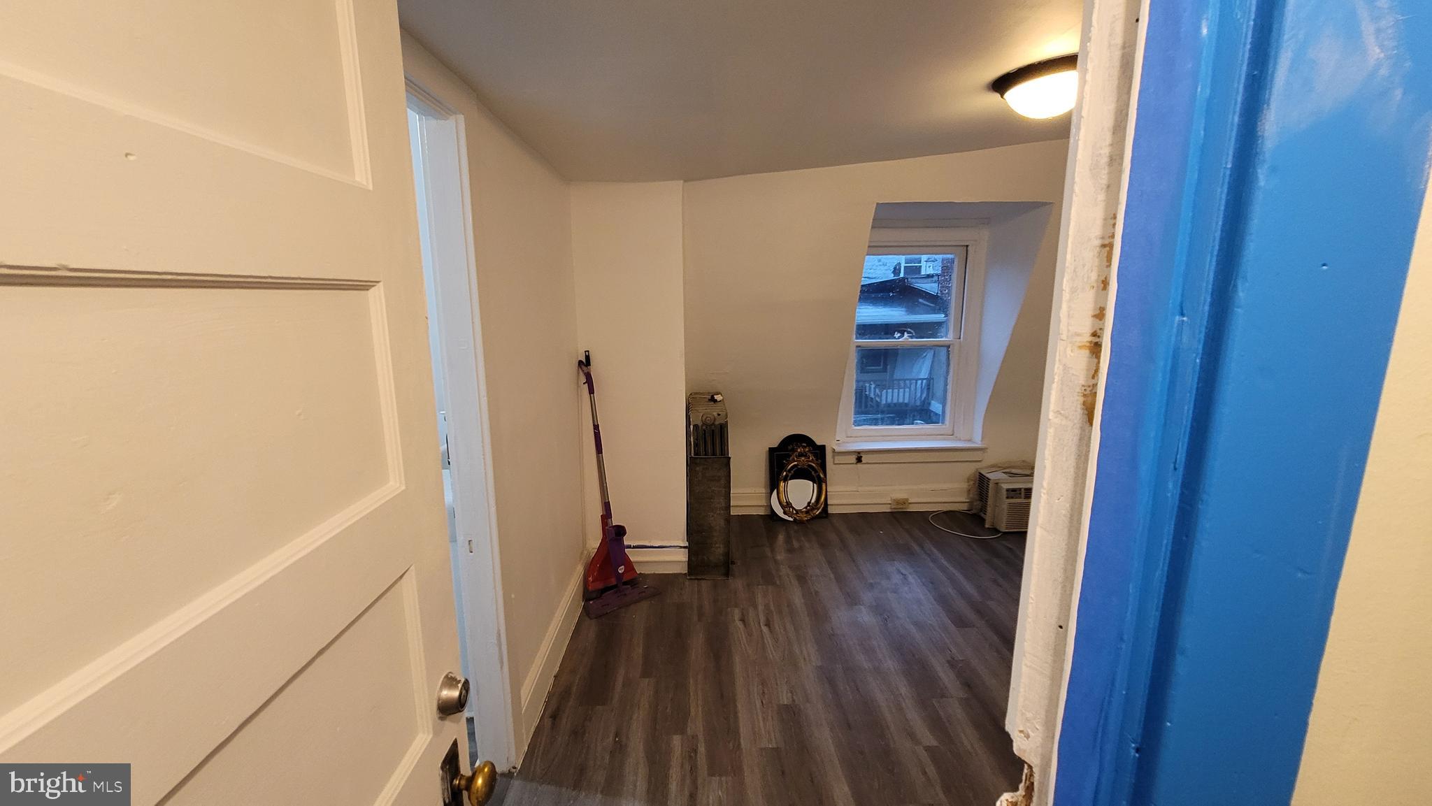 324 Spring Street, Unit 3 Reading, PA 19601 - Photo 23 of 27 a view of front door and bedroom with wooden floor