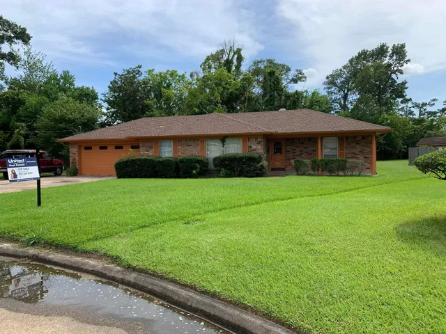 a front view of house with yard and green space