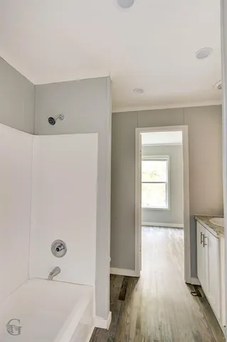 a bathroom with a bathtub and a shower