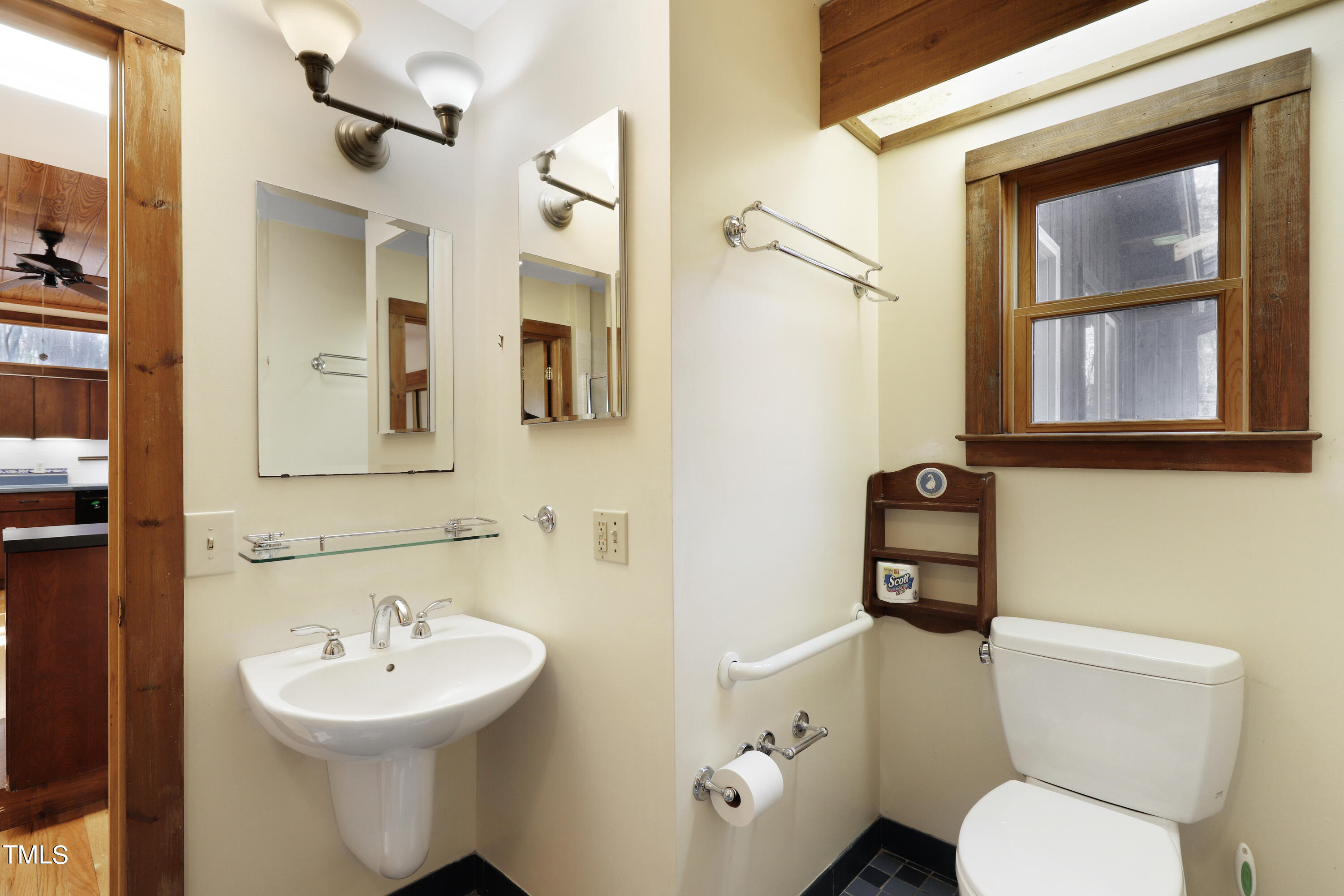 316 Clark Lake Road Durham, NC 27707 - Photo 25 of 65 a bathroom with a toilet sink and mirror
