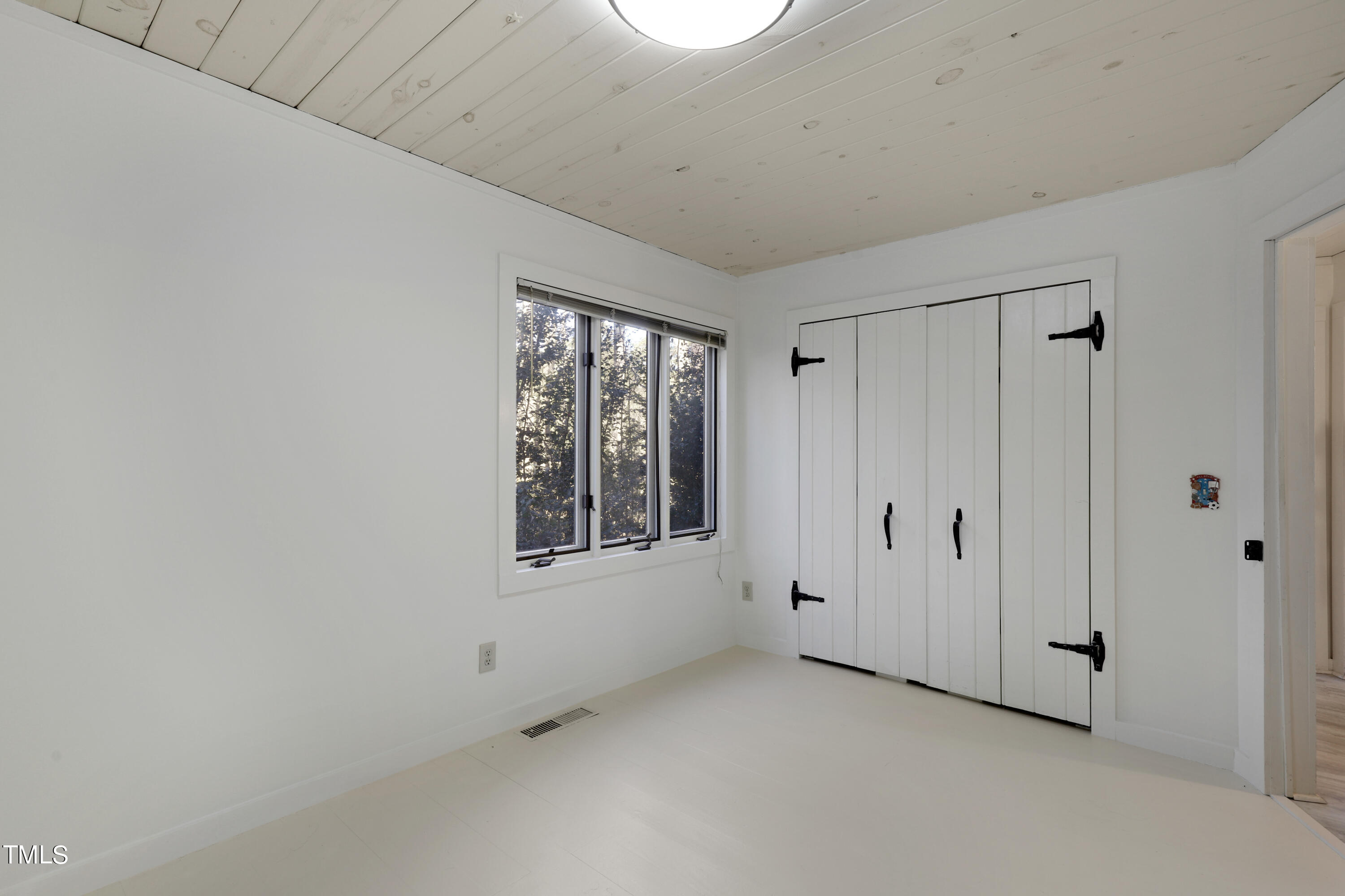 316 Clark Lake Road Durham, NC 27707 - Photo 37 of 65 a view of an empty room with a window