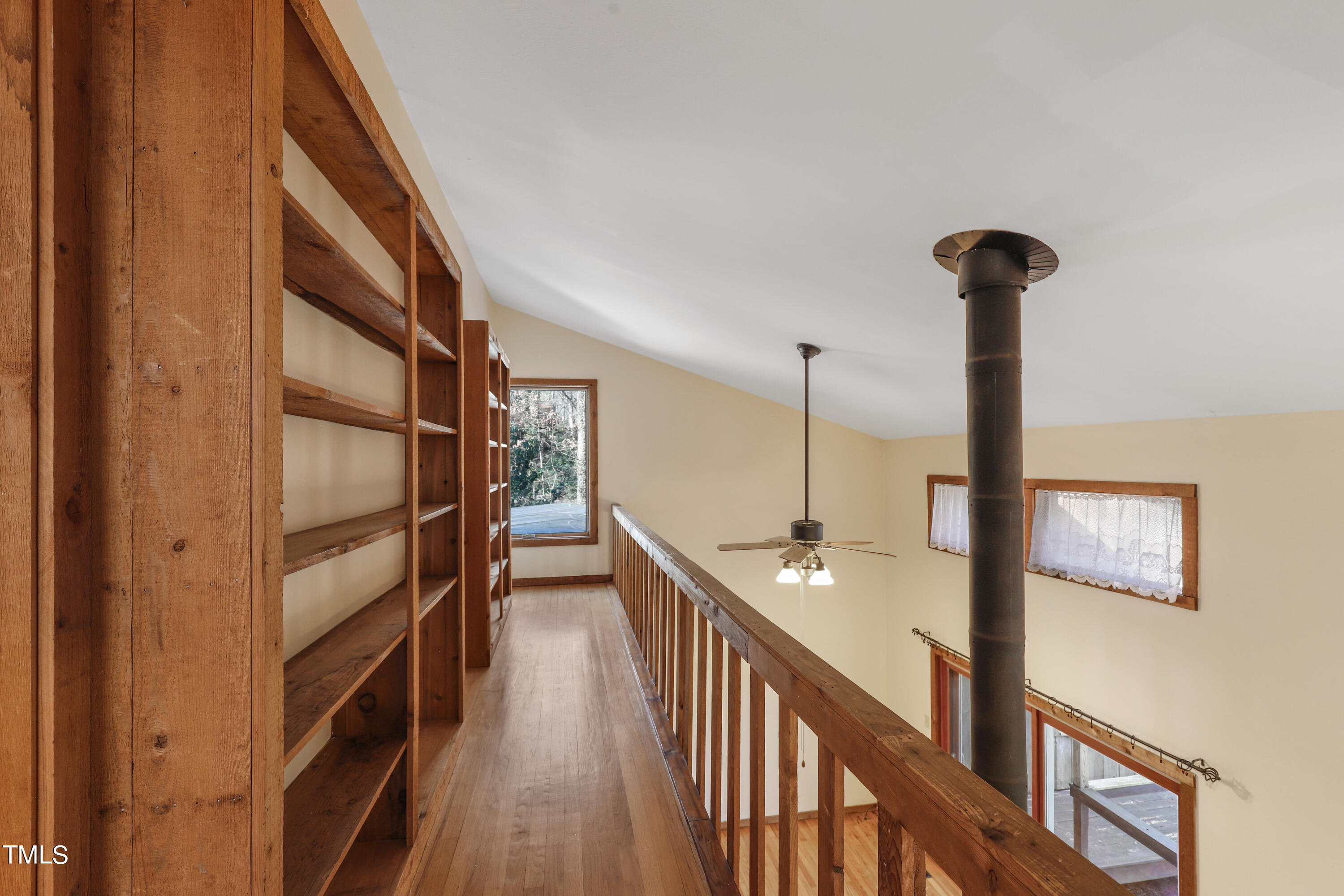 316 Clark Lake Road Durham, NC 27707 - Photo 42 of 65 a view of staircase with lots of frames on wall and wooden floor