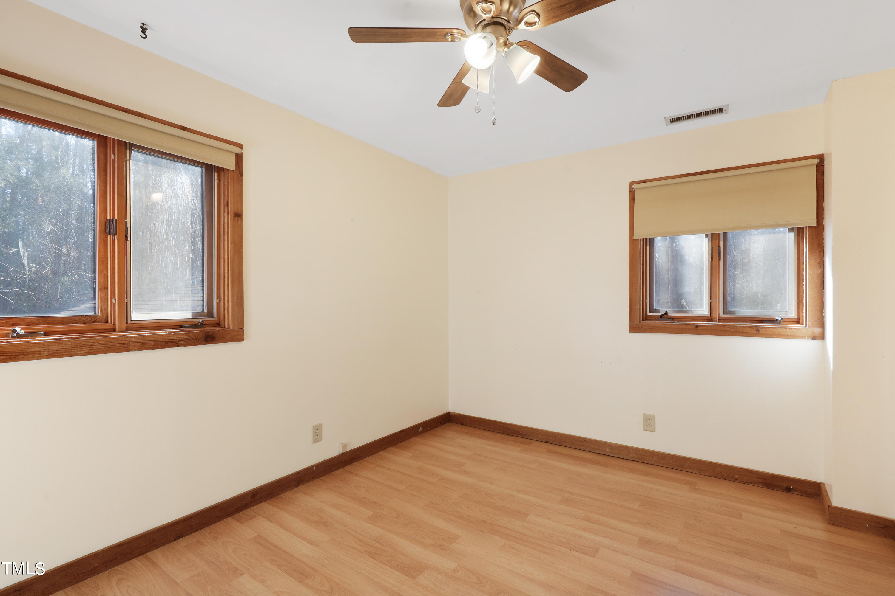 316 Clark Lake Road Durham, NC 27707 - Photo 43 of 65 a view of an empty room with wooden floor and a window