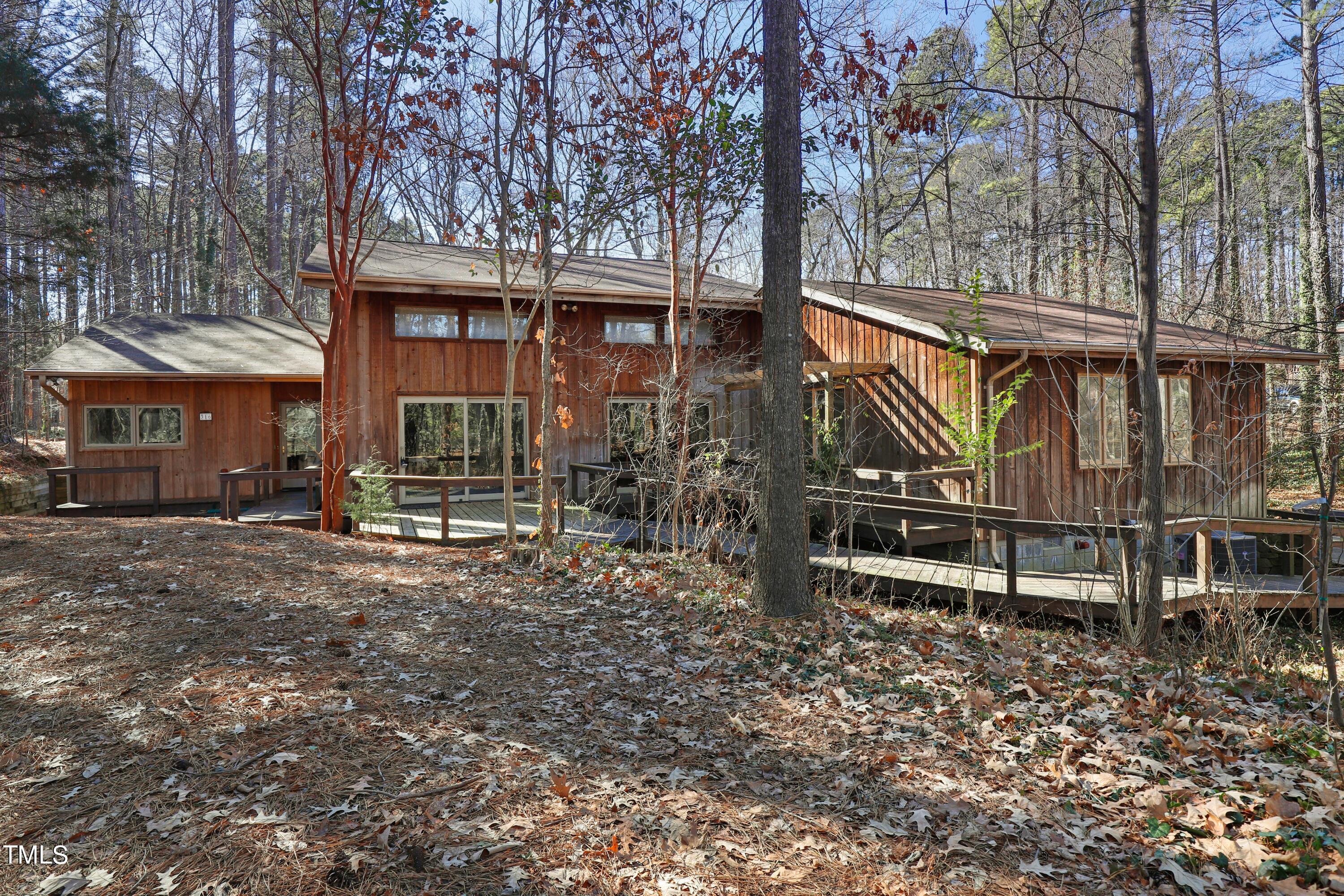 316 Clark Lake Road Durham, NC 27707 - Photo 58 of 65 a front view of a house with garden