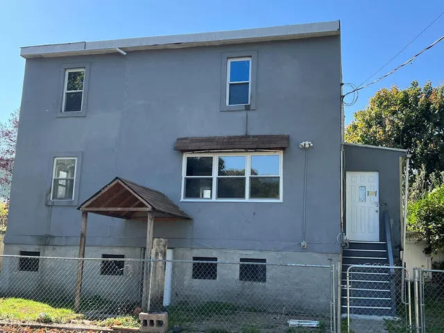 a view of kitchen with refrigerator stove and wooden floor