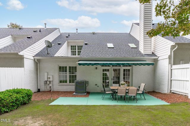 a view of a house with a yard and porch