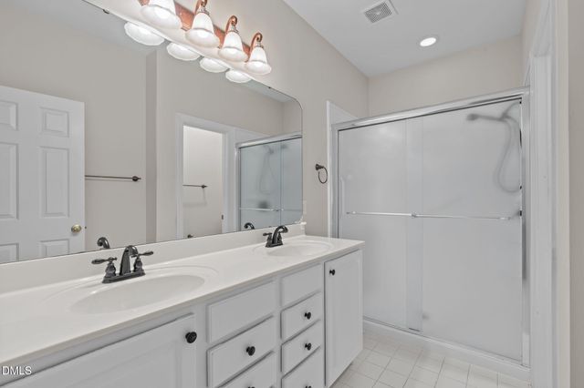 a bathroom with a sink double vanity and a mirror