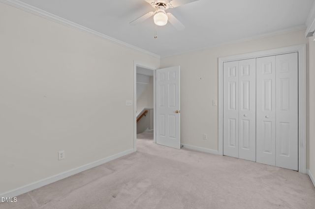 an empty room with a ceiling fan and a window