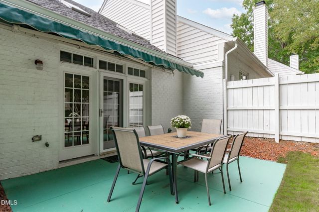 a view of a patio with a table and chairs